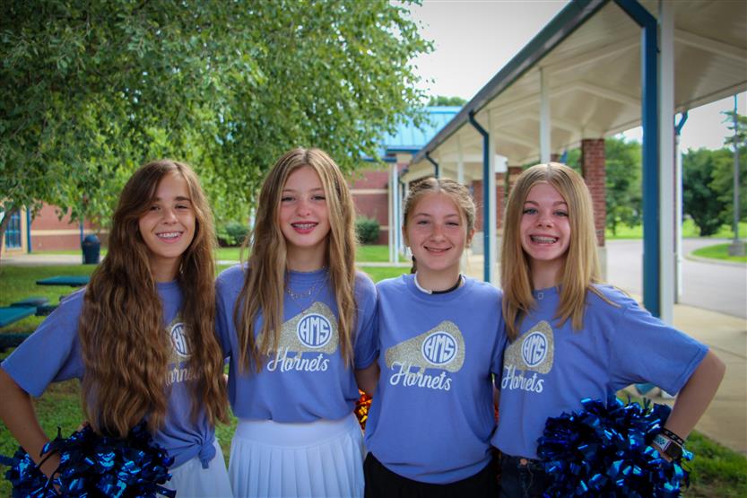Four students smile